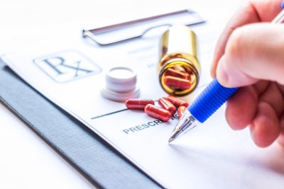 pharmacist writing with a tablets