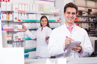 two pharmacist smiling on the pharmacy